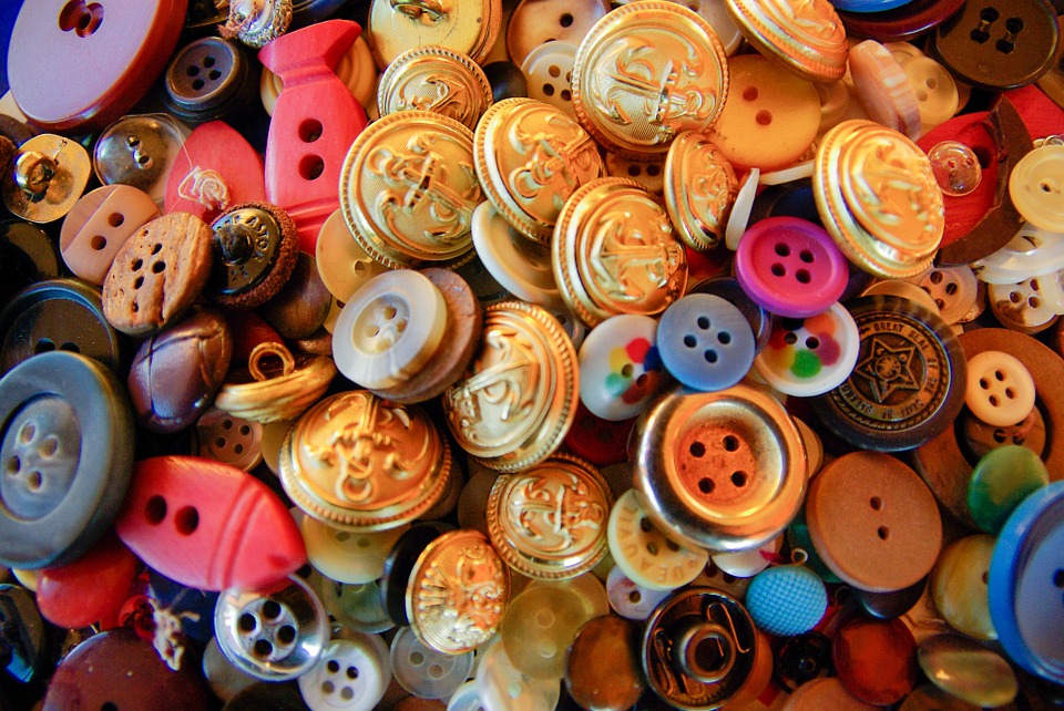 An image of a pile of different buttons