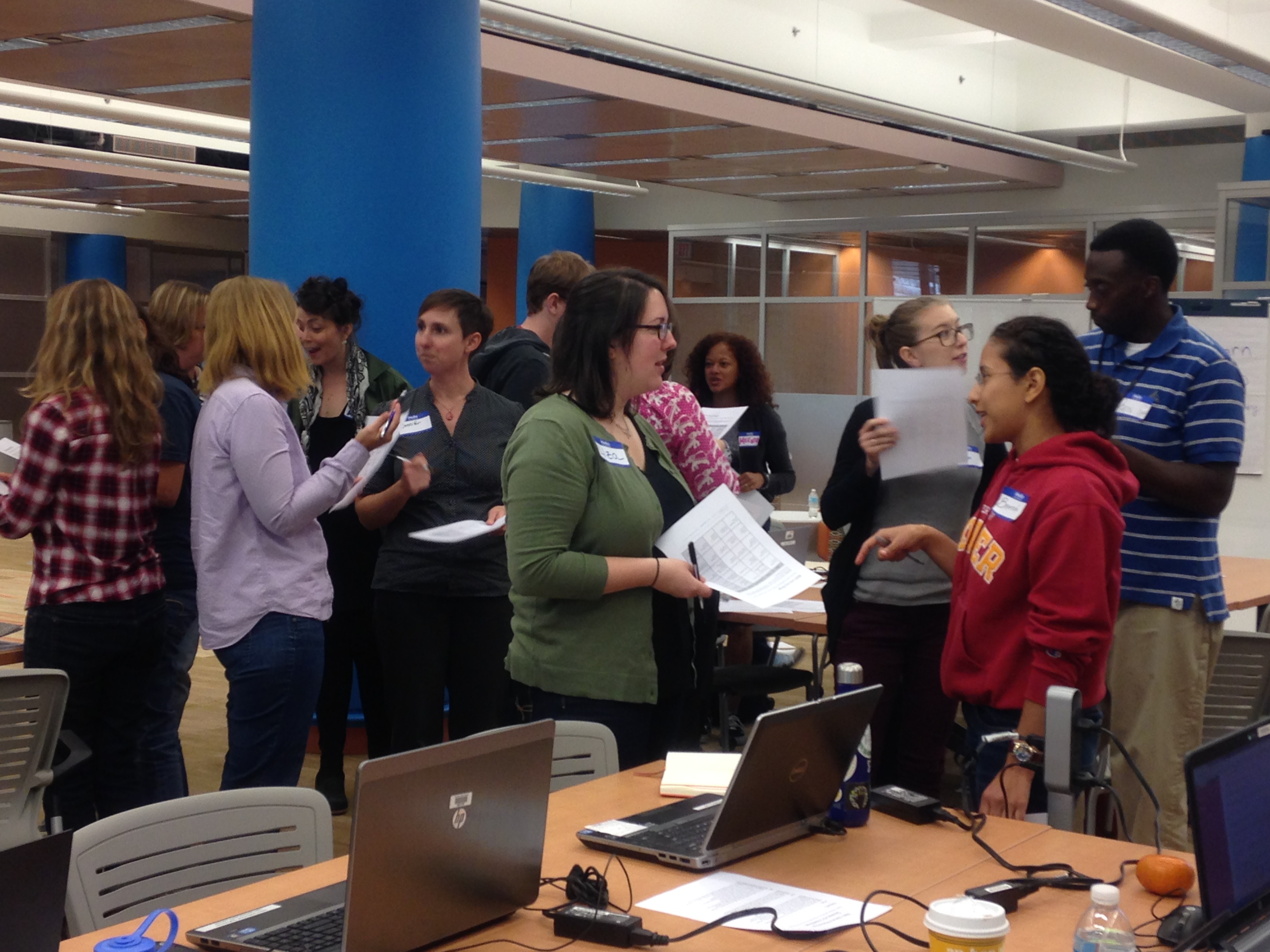 An image of a group of adults exchanging information about web literacy